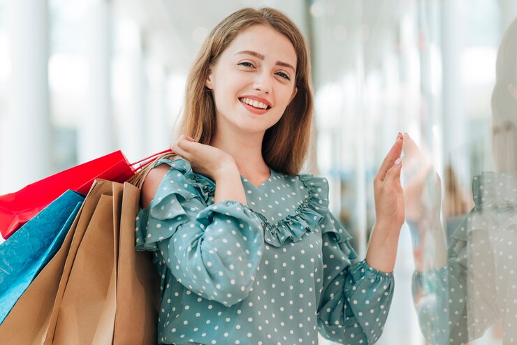 young-girl-holding-shopping-bags-medium-shot